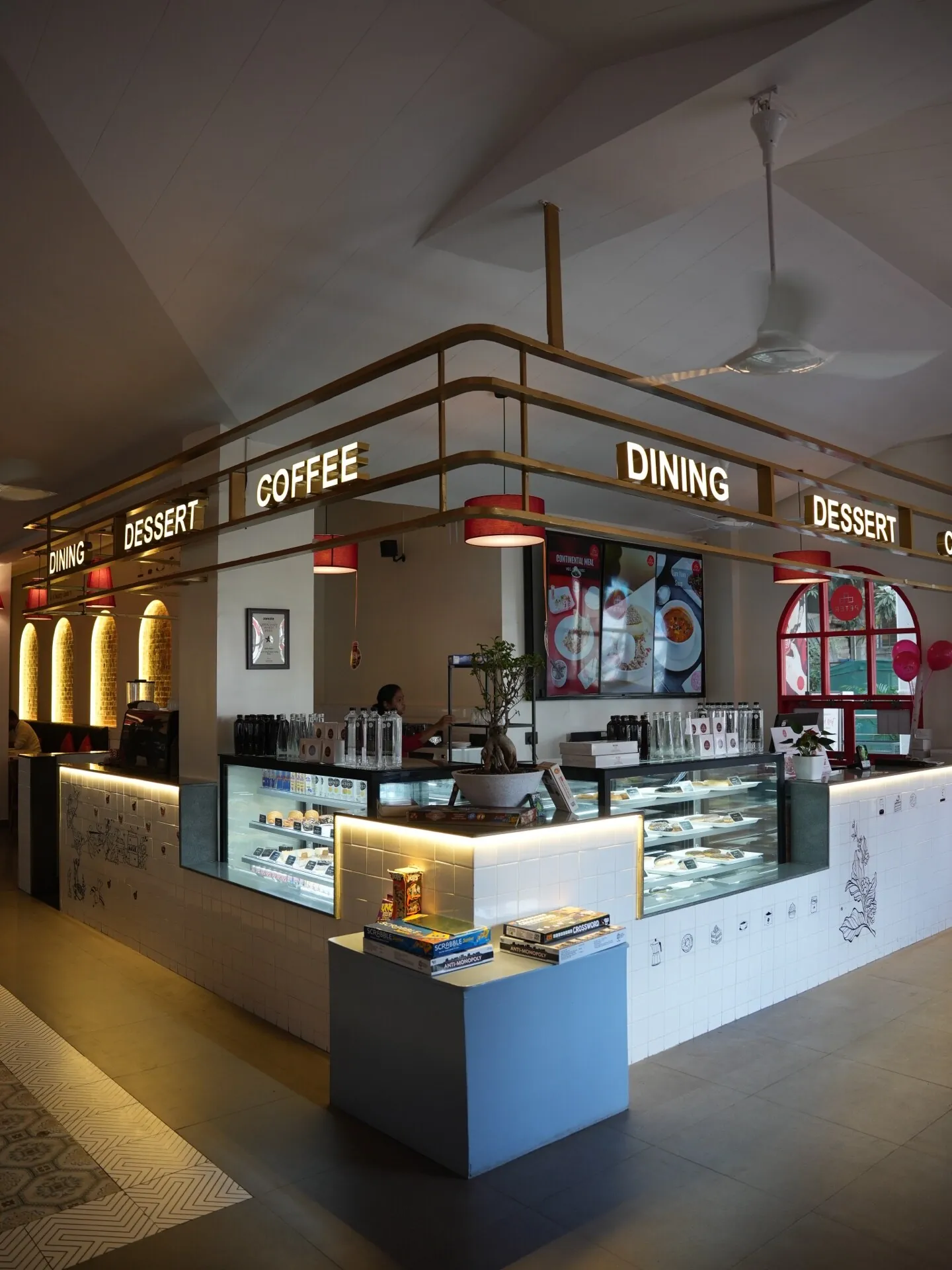 Service counter with warm lighting and display area at Café Peter Erandwane Pune — interior by prāngaṇa.