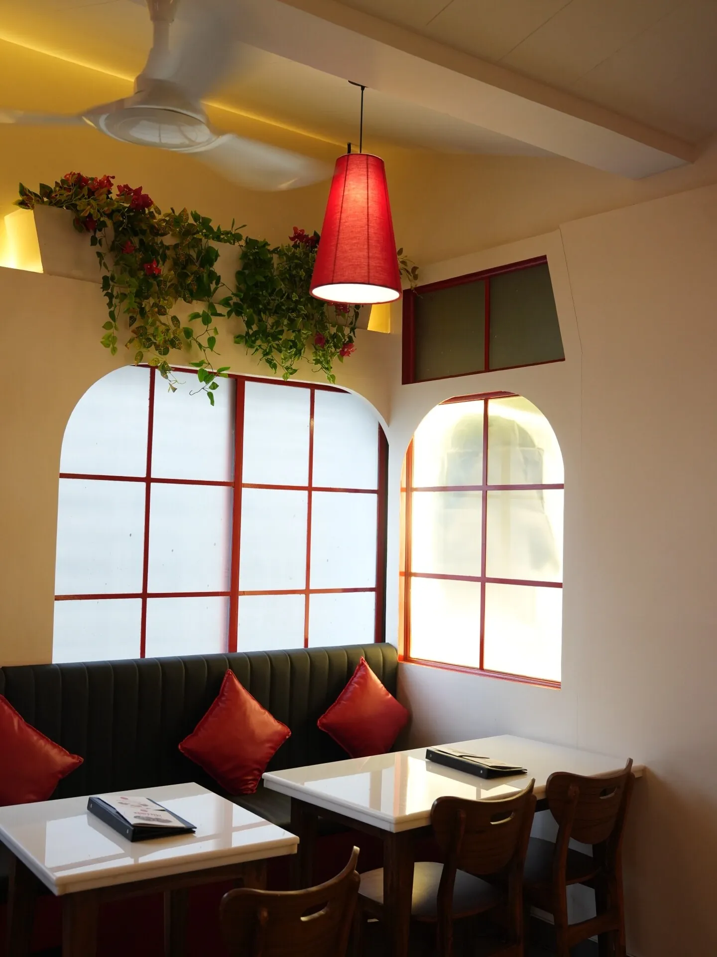 Warm arched corner seating area, Café Peter, Erandwane, Pune — interior design by prāngaṇa.