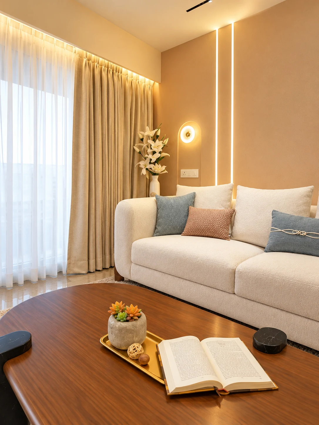 Sofa beside full-height curtains, with blue cushions and a wood-toned coffee table.