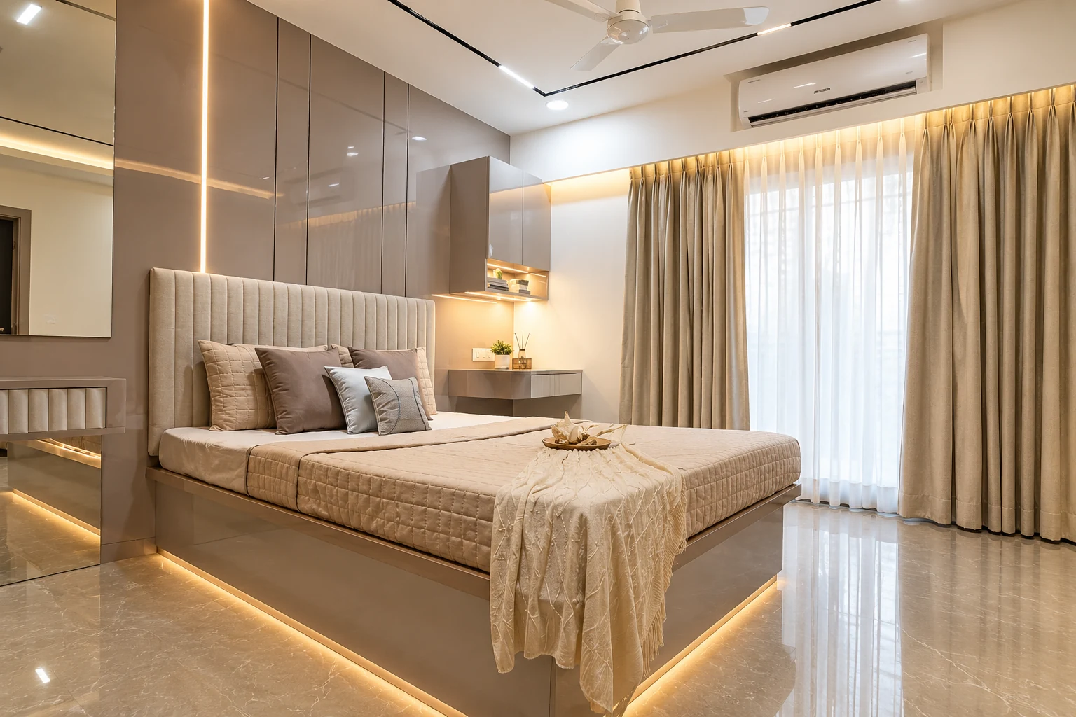 Bedroom with a padded headboard, neutral bedding and warm perimeter lighting.